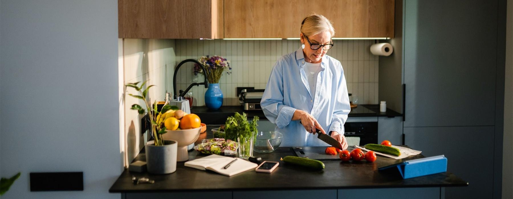 a woman cutting vegetables in the kitchen
