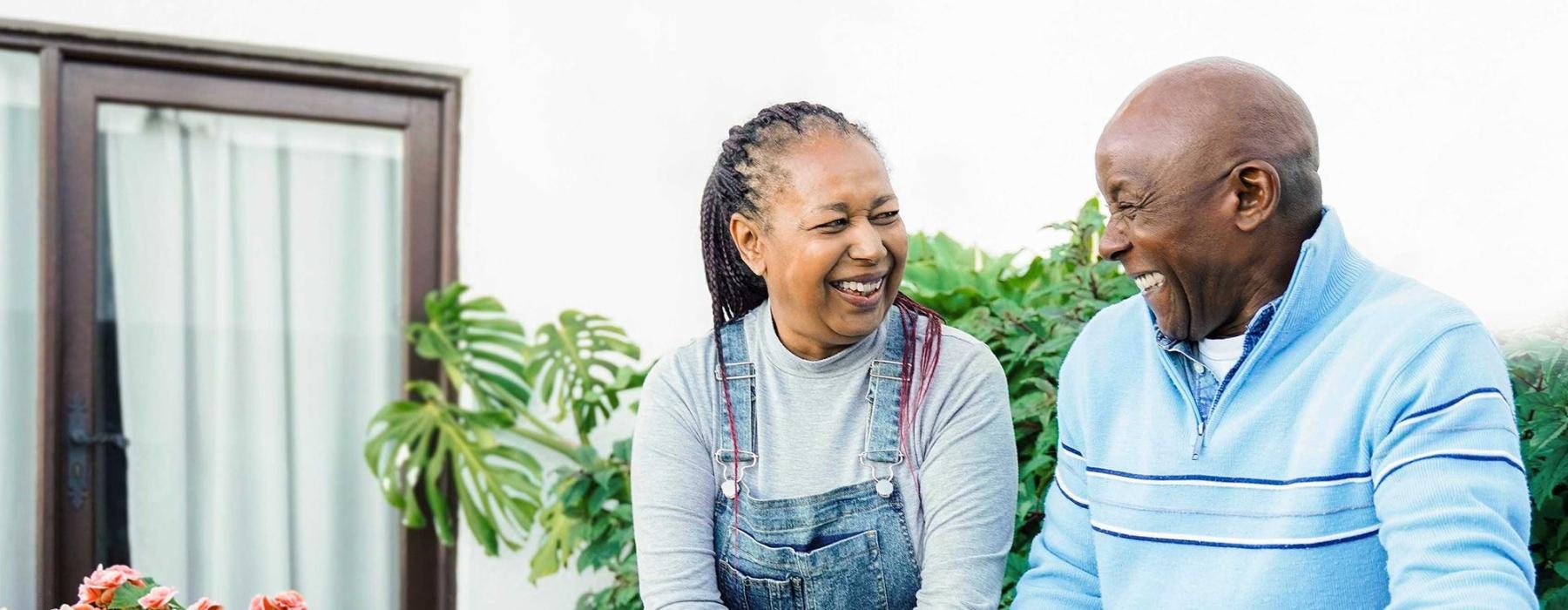 a man and a woman smiling while gardening